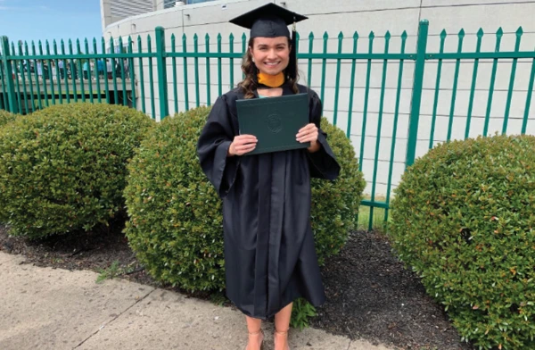 A young woman in her commencement attire.